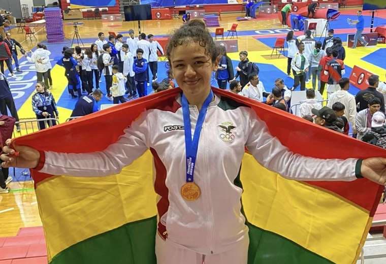 Celeste Áñez luce orgullosa la bandera boliviana y su medalla de oro. Foto: C. Áñez