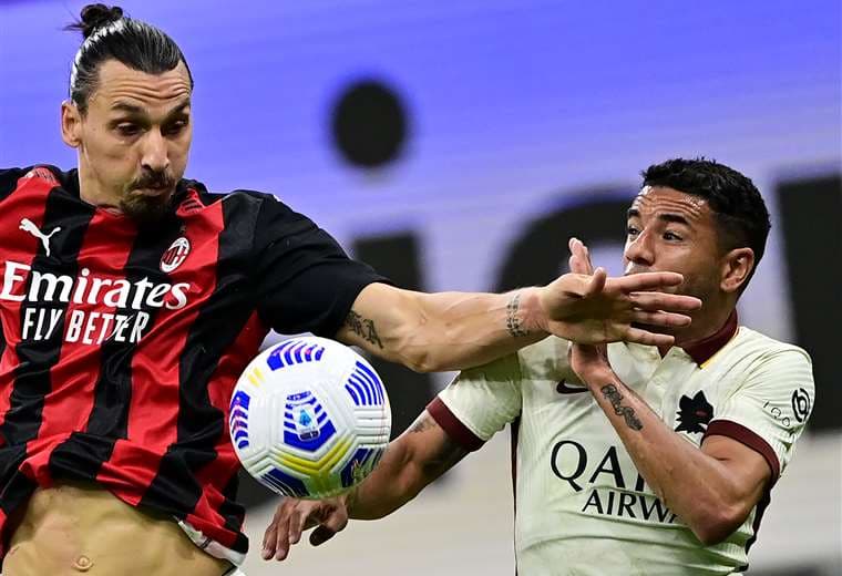 Ibrahimovic disputa la pelota con Peres, de la Roma. Foto: AFP