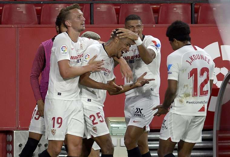 El brasileño Fernando (25) es felicitado por sus compañeros tras marcar el segundo gol del Sevilla. Foto: AFP